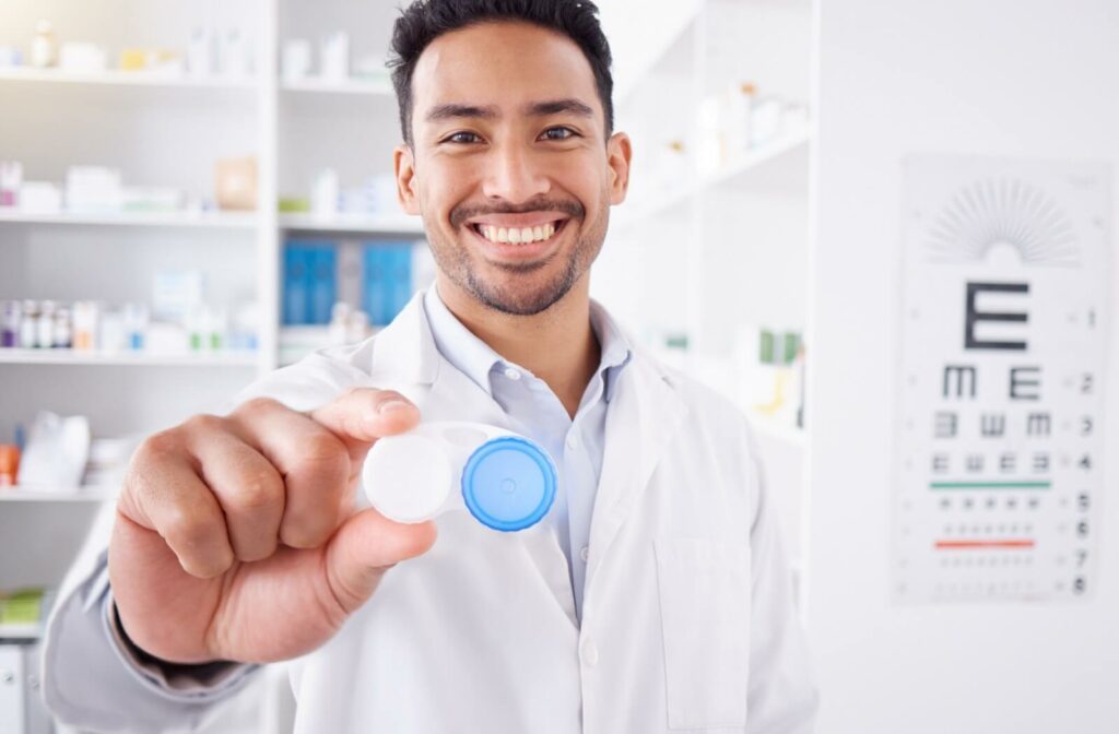 A happy optometrist holding a contact lens case.
