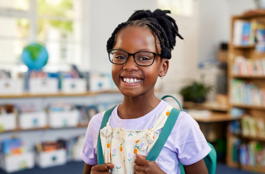 A child enjoys crisp, clear vision at school thanks to their myopia control eyeglasses.