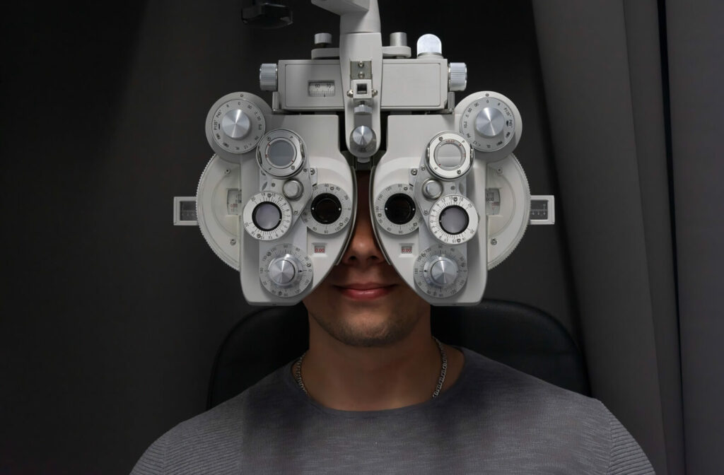Patient undergoing a vision test using a phoropter during an eye exam.